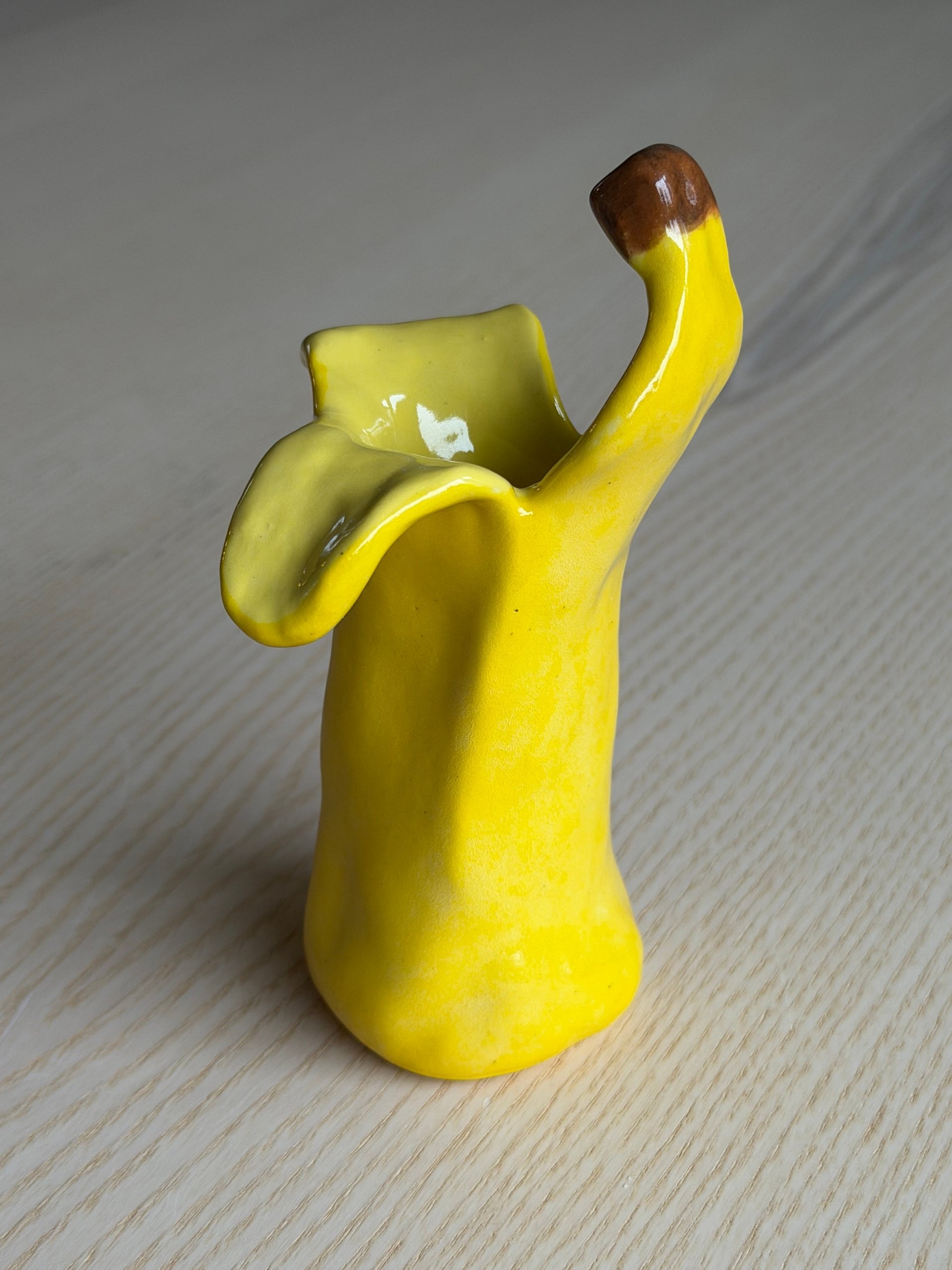 The second cup, its peel curling up to a point with the stem at the top