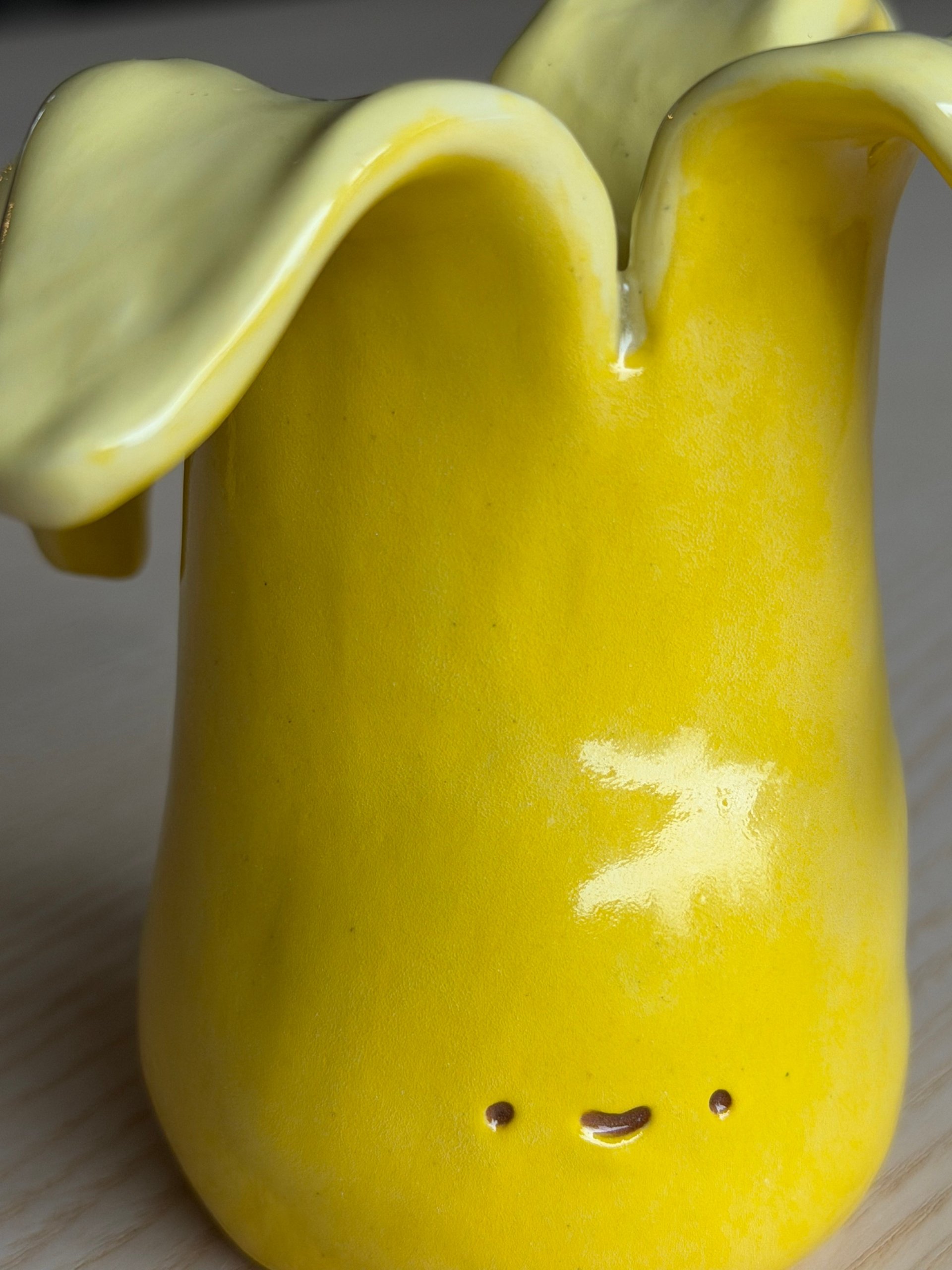 The peel flaring open above the cup's face