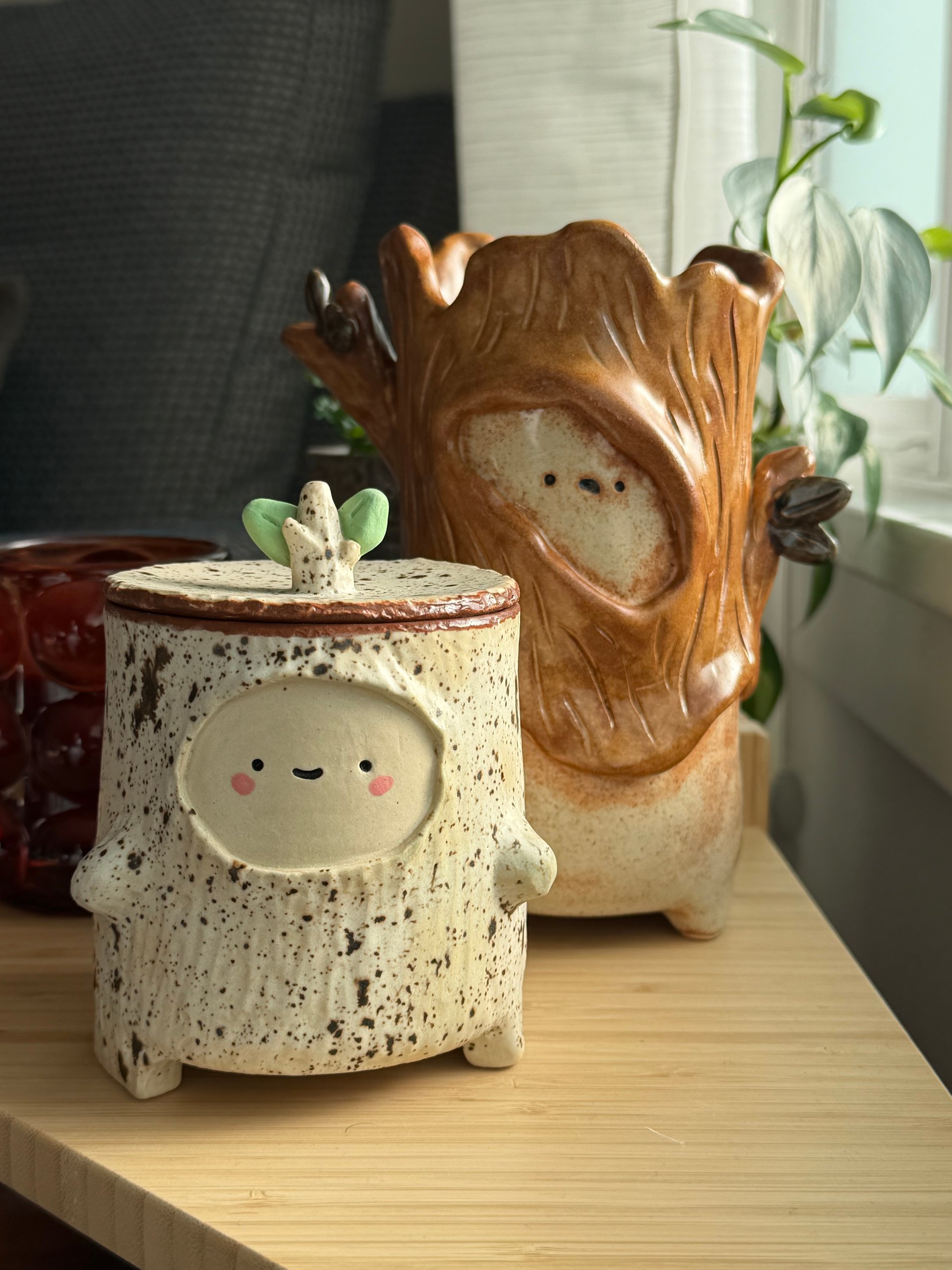 The jar on a windowsill beside the sprite in a log