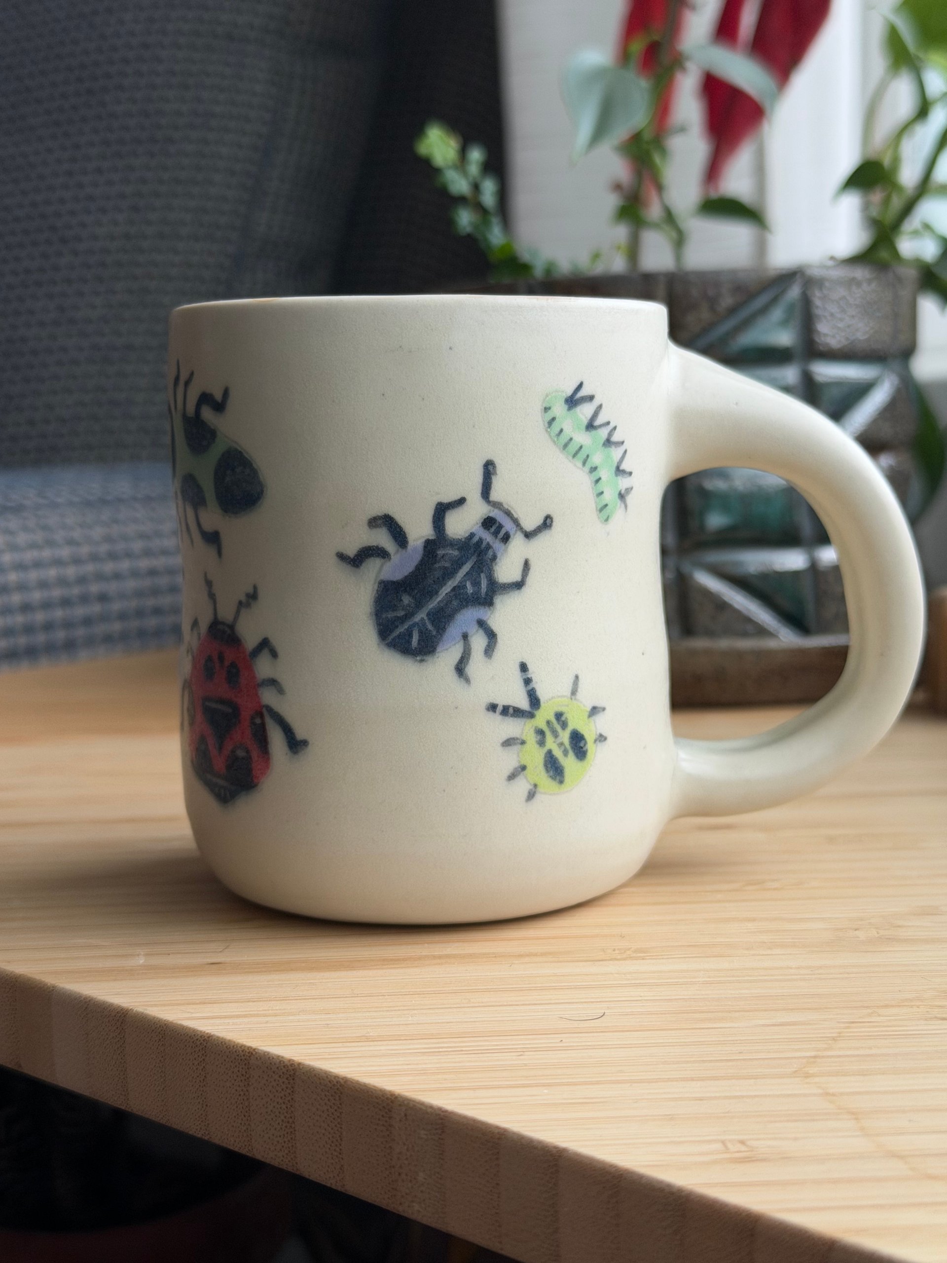 The other side of the mug, more bugs wrapping around towards the handle