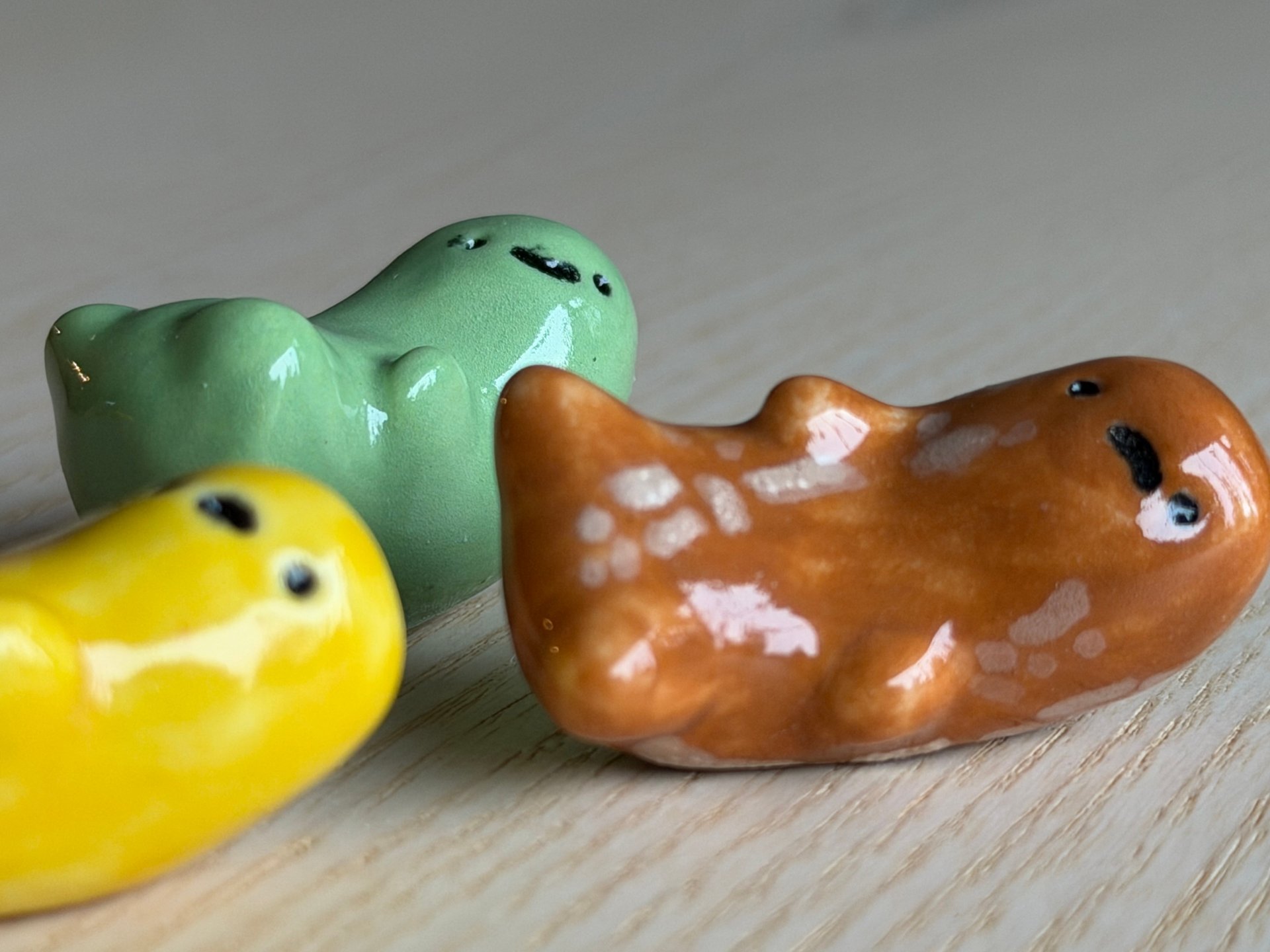 A green, a yellow and a brown bean gathered together