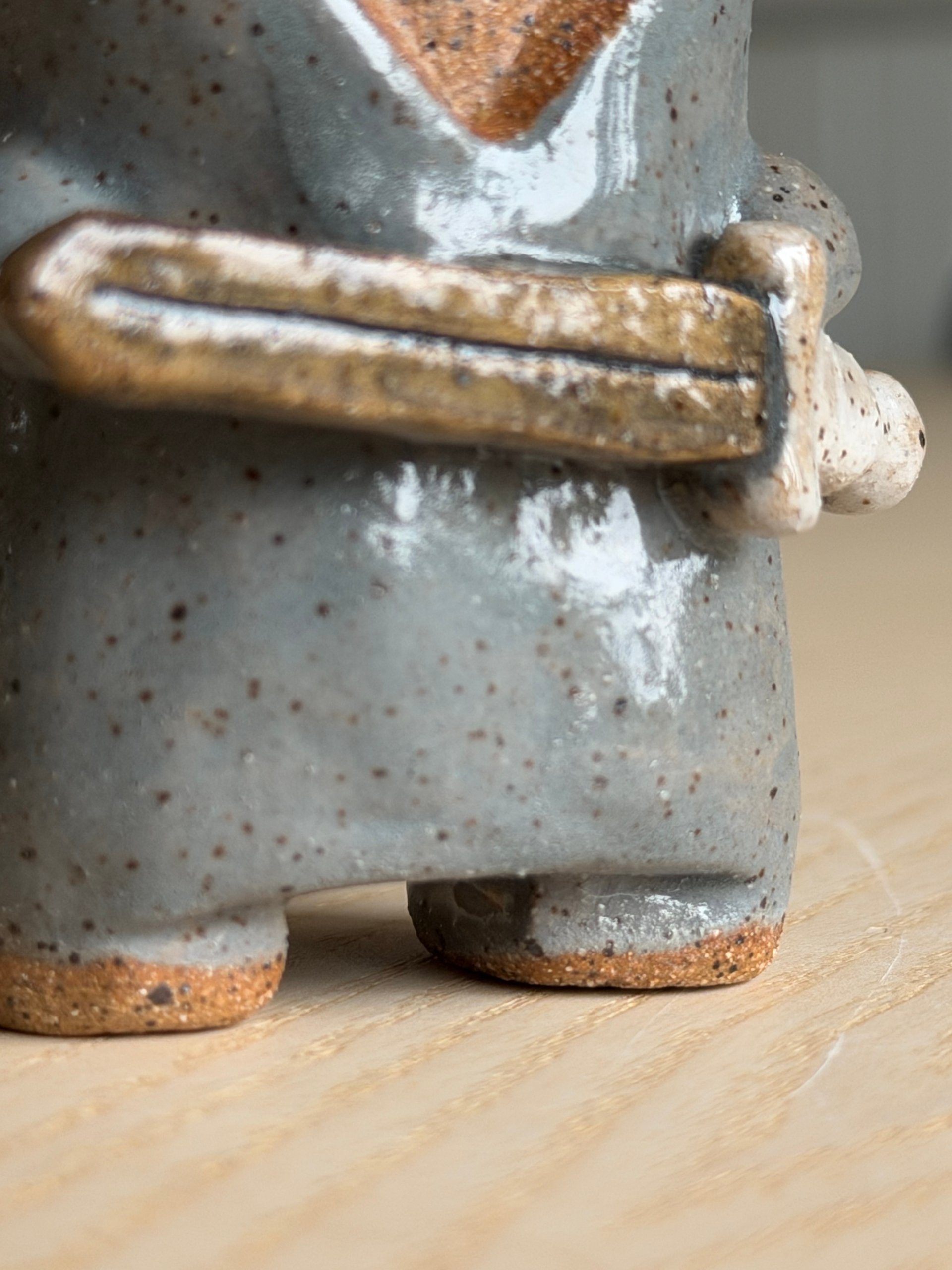 Detail of the sword and the little feet at the base