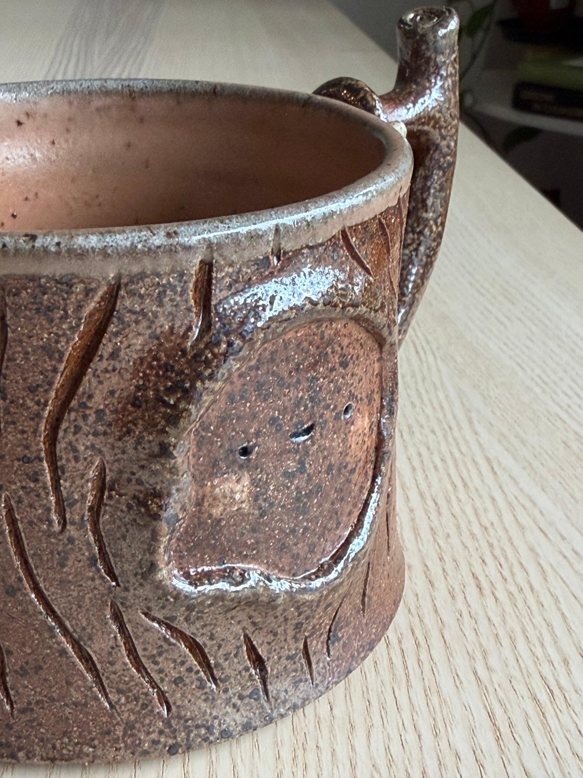 A closed-eyed face set deep in the dark bark