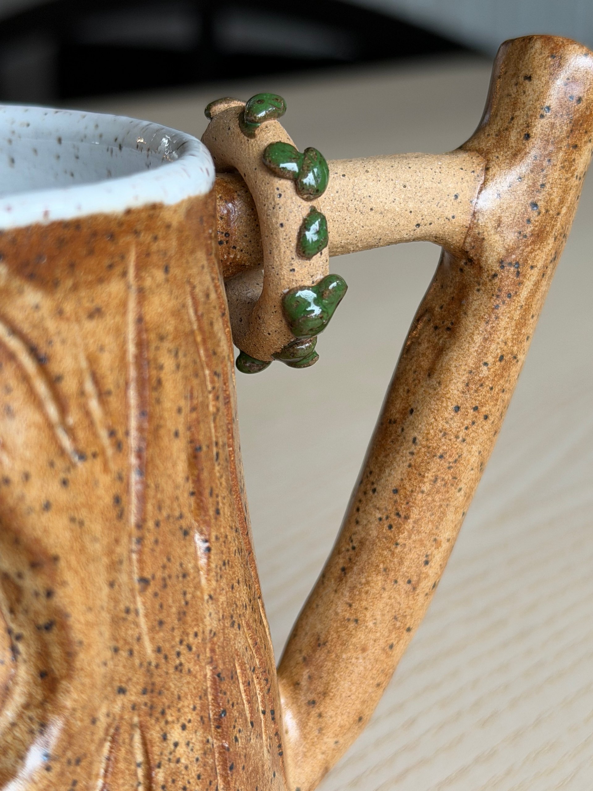 Ivy winding up the branch handle of the honey mug